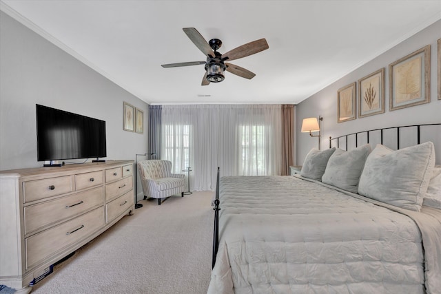 bedroom with crown molding, ceiling fan, and light carpet