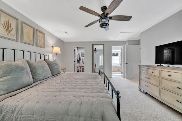 bedroom featuring visible vents, light colored carpet, ornamental molding, and a spacious closet
