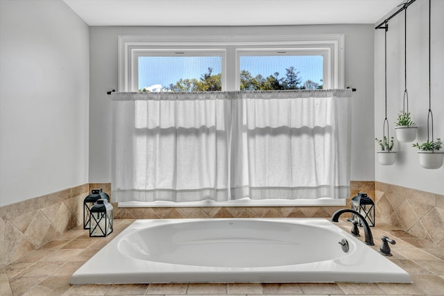 bathroom featuring plenty of natural light and a garden tub