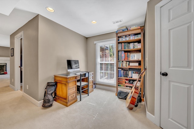 carpeted home office featuring baseboards, a brick fireplace, recessed lighting, and visible vents