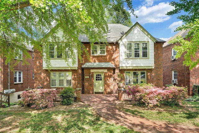 townhome / multi-family property with brick siding and a shingled roof
