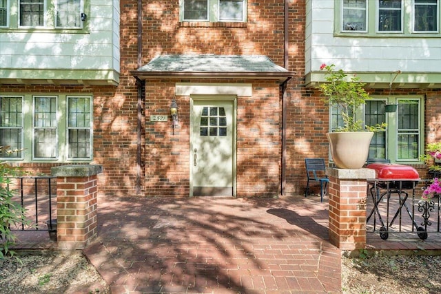 exterior space featuring a patio and brick siding