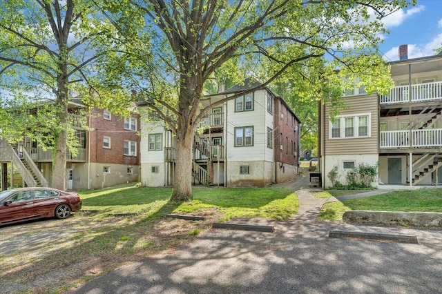 surrounding community featuring stairs and a lawn