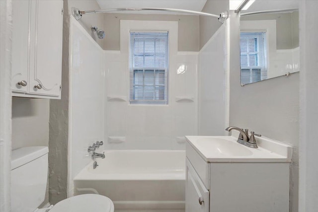 bathroom featuring toilet, vanity, and shower / bathing tub combination