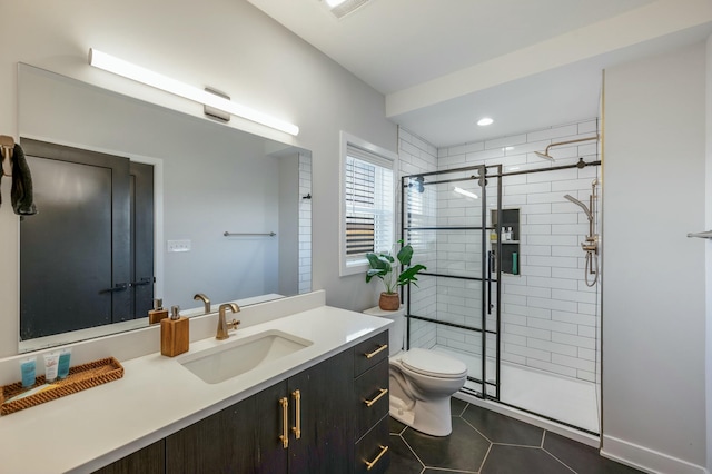 bathroom featuring a stall shower, tile patterned floors, vanity, and toilet