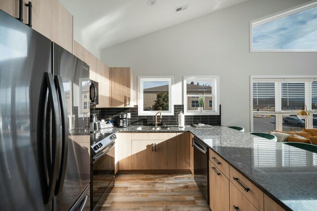 101 Retreat Ln, Huddleston, VA 24104 - kitchen with dark stone countertops, a sink, black appliances, light wood-style floors, and visible vents