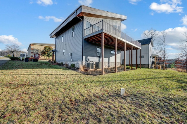 back of property with a wooden deck and a yard