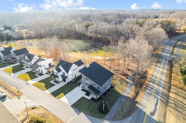 birds eye view of property with a residential view and a wooded view