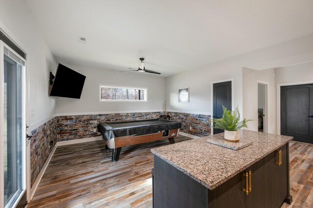 game room featuring pool table, a ceiling fan, a wainscoted wall, and light wood finished floors