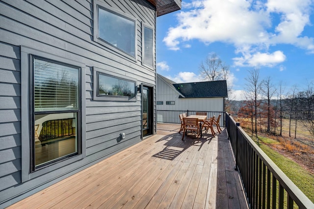 wooden deck featuring outdoor dining area