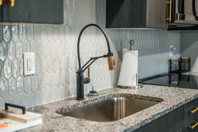 101 Retreat Ln, Huddleston, VA 24104 - details featuring backsplash, light stone countertops, and a sink