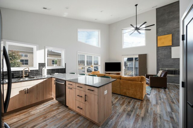101 Retreat Ln, Huddleston, VA 24104 - kitchen with a peninsula, stainless steel dishwasher, dark stone countertops, and wood finished floors
