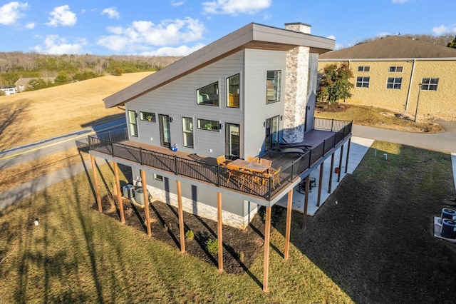 back of property featuring a wooden deck
