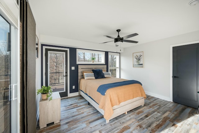 bedroom featuring ceiling fan, wood finished floors, baseboards, and access to outside