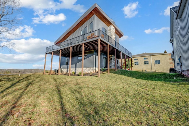 rear view of house featuring a yard and a deck