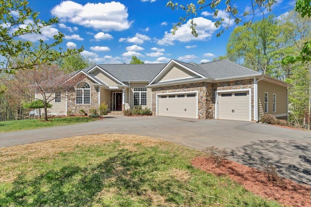 view of front of house with a garage, stone siding, a front lawn, and aphalt driveway