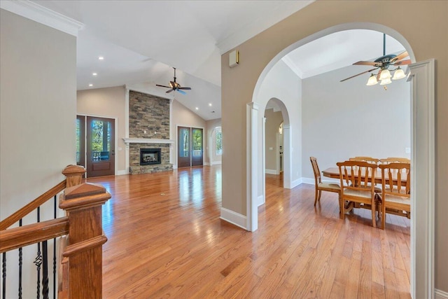 living area featuring light wood finished floors, ceiling fan, and plenty of natural light