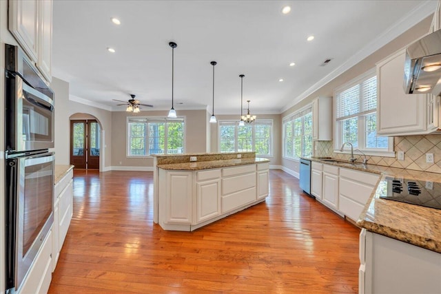 kitchen with crown molding, dishwasher, black electric stovetop, and plenty of natural light