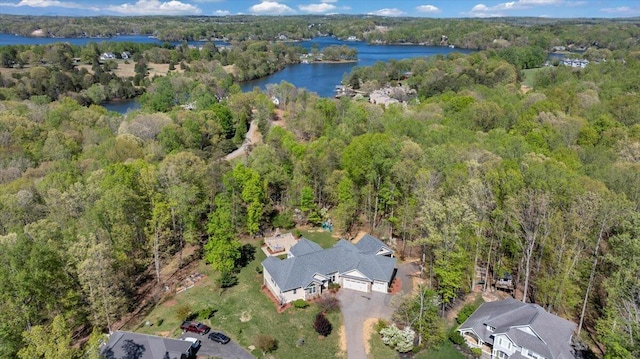 birds eye view of property featuring a water view and a forest view