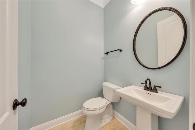 bathroom featuring tile patterned floors, a sink, toilet, and baseboards