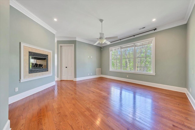 unfurnished living room with visible vents, crown molding, and wood-type flooring