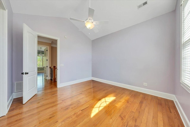 empty room with baseboards, visible vents, a ceiling fan, and light wood-style flooring