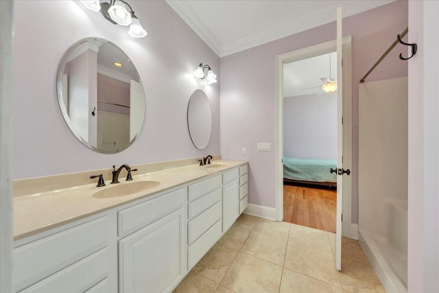 bathroom with double vanity, ornamental molding, tile patterned flooring, and a sink