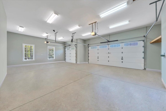 garage with a garage door opener and baseboards