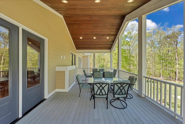 sunroom with outdoor dining space and a wealth of natural light