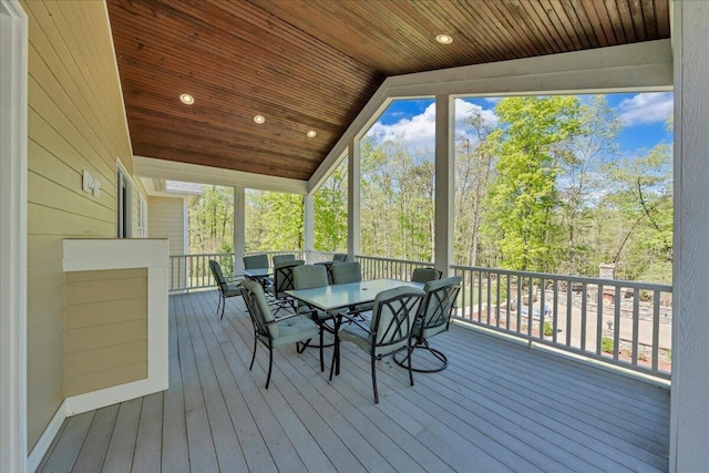 sunroom / solarium featuring outdoor dining space