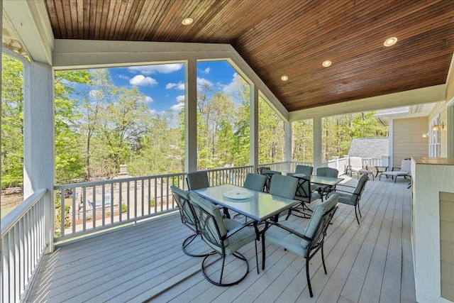 sunroom featuring outdoor dining space