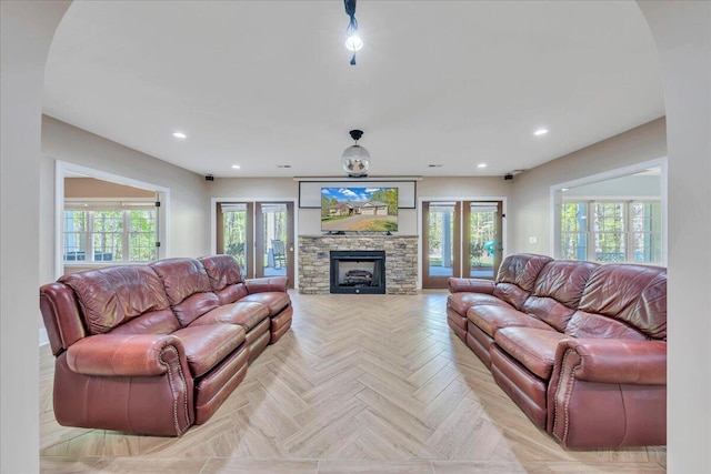 living room featuring a fireplace, plenty of natural light, and recessed lighting