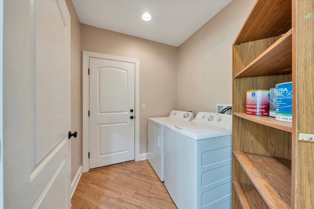 laundry area with recessed lighting, laundry area, washer and dryer, light wood-style floors, and baseboards