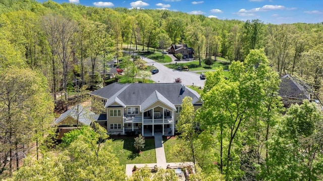 birds eye view of property featuring a wooded view