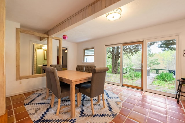 dining room with baseboards and light tile patterned floors
