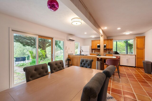 dining area with light tile patterned floors, recessed lighting, and a wall unit AC