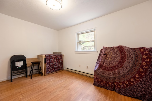 sitting room featuring wood finished floors and a baseboard radiator
