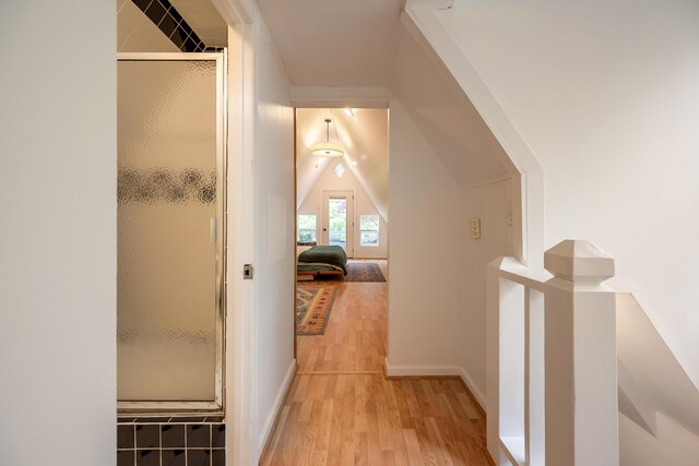 corridor with baseboards and wood finished floors