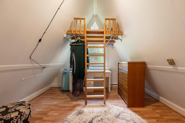 spacious closet with wood finished floors and vaulted ceiling