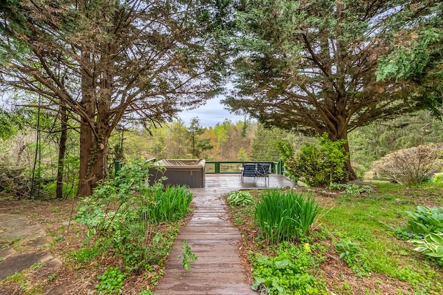 view of home's community featuring a deck and a forest view