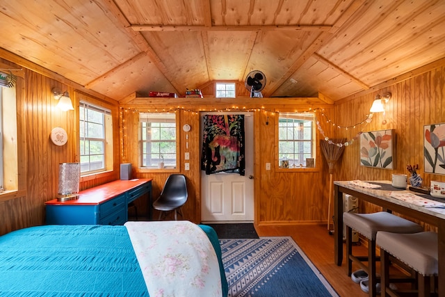 bedroom featuring wood walls, wood ceiling, and multiple windows