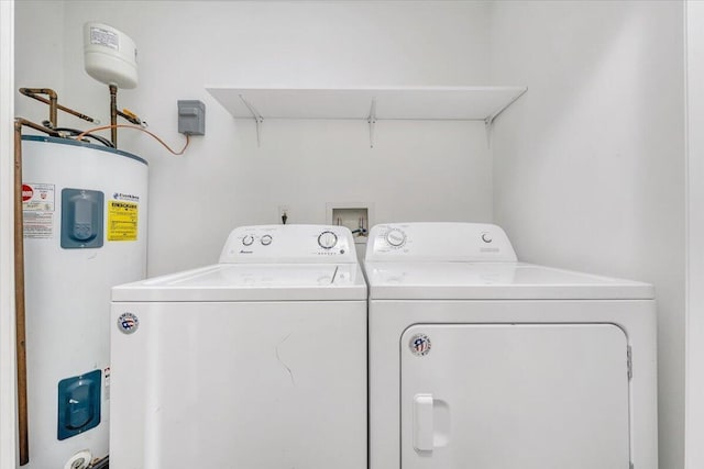 washroom featuring laundry area, washer and clothes dryer, and water heater