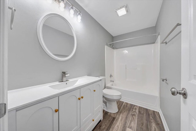 full bathroom featuring visible vents, wood finished floors, shower / washtub combination, vanity, and toilet