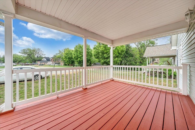 wooden terrace with a lawn