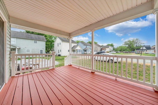 wooden deck featuring a yard and a residential view