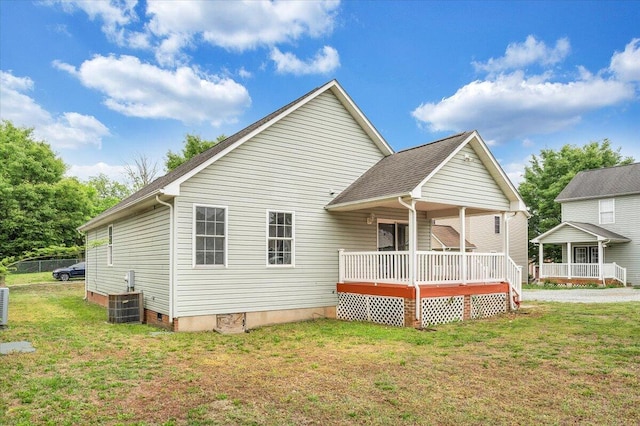 rear view of house with central AC unit, a yard, a porch, and crawl space