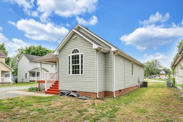 exterior space with crawl space and a front lawn