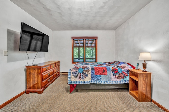 carpeted bedroom with baseboard heating and baseboards
