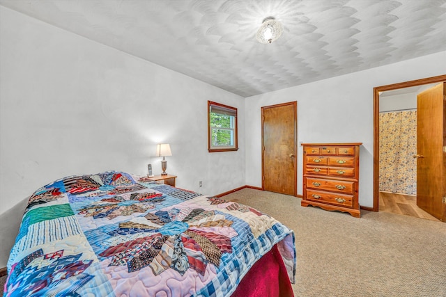 carpeted bedroom featuring baseboards