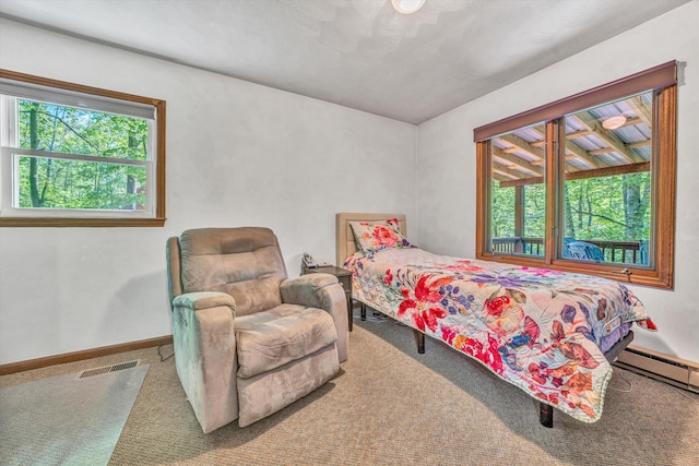carpeted bedroom featuring baseboards, visible vents, and a baseboard radiator